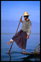 Leg rowing Intha fisherman in sampan on Inle Lake in Shan State.