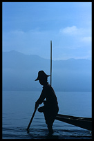 Leg rowing Intha fisherman in sampan on Inle Lake in Shan State.