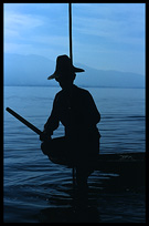 Leg rowing Intha fisherman in sampan on Inle Lake in Shan State.