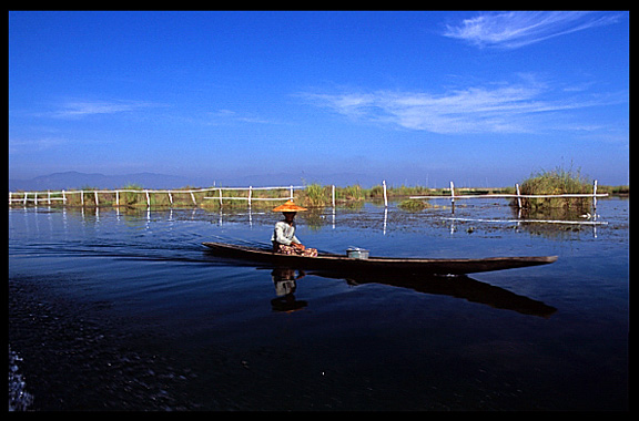 A Burmese woman in a canoe on Inle Lake.