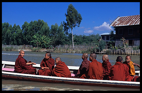 Young monks in motorboat on Nankand Canal connecting Nyaungshwe with Inle Lake.
