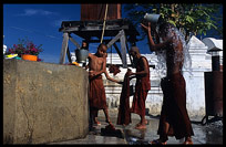 Monks washing and showering at  Shwe Yaunghwe Kyaung, an 18th-century wooden monastery near Inle Lake.