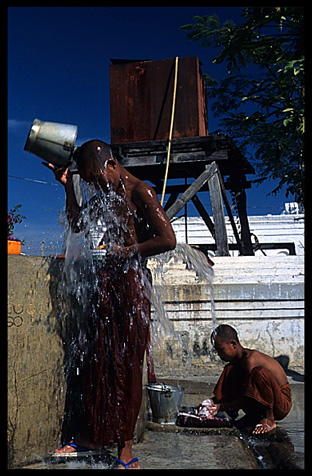 Monks washing and showering at  Shwe Yaunghwe Kyaung, an 18th-century wooden monastery near Inle Lake.