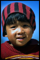 A Burmese child is smiling.