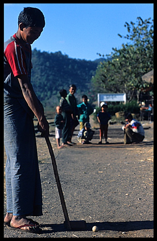 Playing golf on the Railway station in the village of Myin Saing Gone on the Shan Plateau near Kalaw.