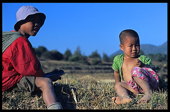 Two Burmese children sitting in the field on the Shan Plateau near Kalaw.