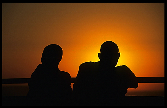 Silhouettes of monks during sunset at Mandalay Hill.