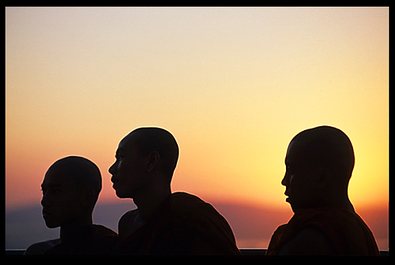 Silhouettes of monks during sunset at Mandalay Hill.