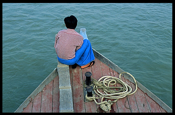 A captain and his boat on the Ayeyarwady river.