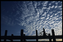 A man with a bicycle crossing the U Bein Bridge at Amarapura.