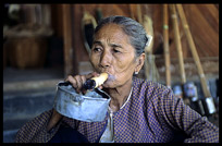 A Burmese woman smoking a very large cheroot in Minnanthu near Bagan.