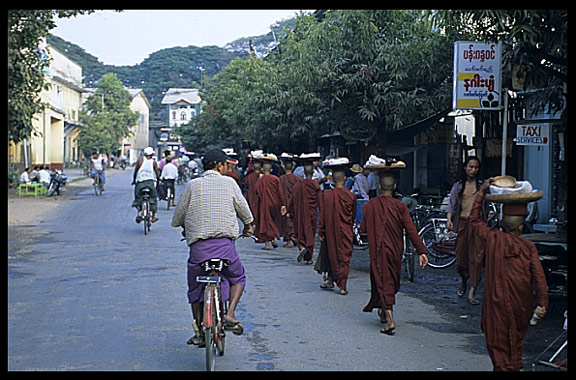 Monks in Pyay are walking down the street asking for gifts and food.