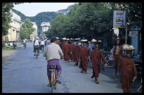 Monks in Pyay are walking down the street asking for gifts and food.