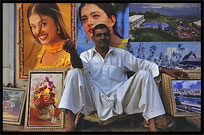 A merchant is selling posters of famous Indian movie stars. Lahore, Pakistan