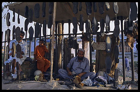 Repairing shoes. Taxila, Pakistan