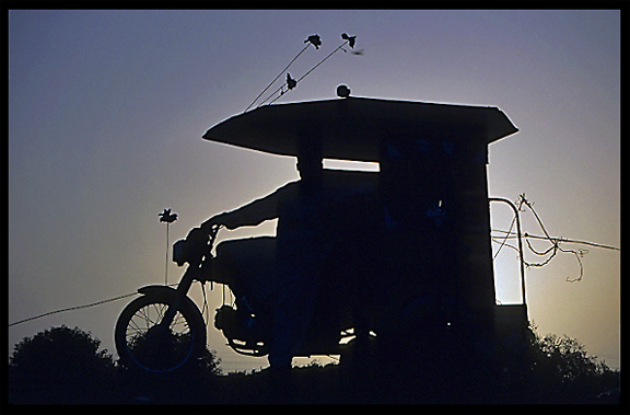 Silhouette of a motor-rickshaw. Taxila, Pakistan