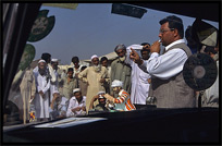 A charlatan tries to sell his "medicines" to Afghan refugees on the Afghan horse market. Peshawar, Pakistan