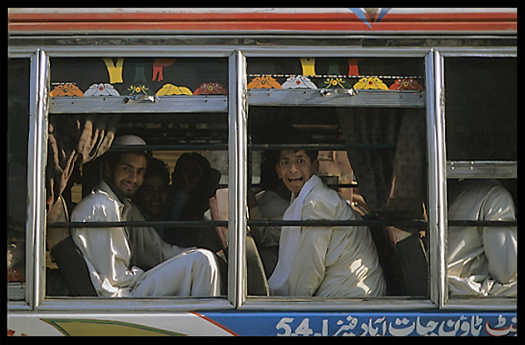 Colourful Pakistanis in colourful bus. Peshawar, Pakistan
