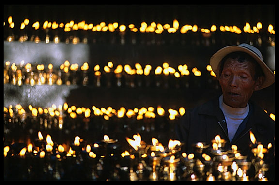 Yak-butter lamps light the darkness.