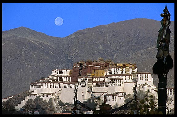The moon sets over the Potala Palace from the roof of the Jokhang.