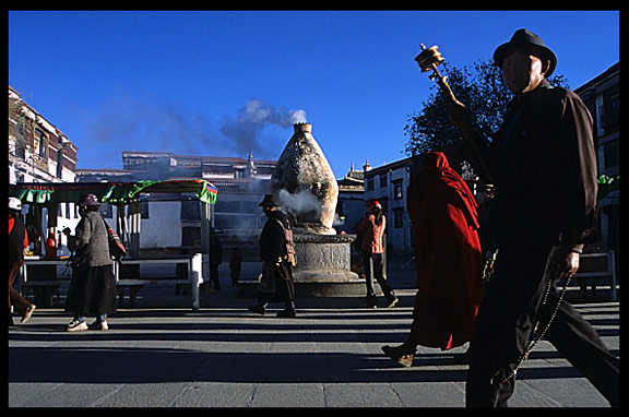 Pilgrims in front of one of the incense burners on the Barkhor Kora.