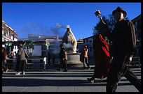 Tibetan pilgrims in front of one of the incense burners on the Barkhor Kora. Lhasa, Tibet, China