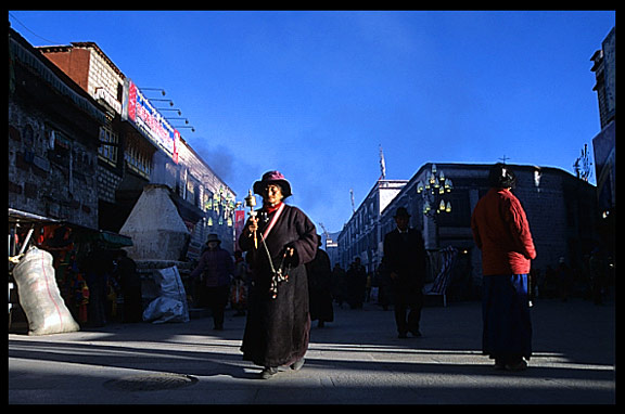 Colourful pilgrims following the Barkhor Kora on the east side of the Jokhang.