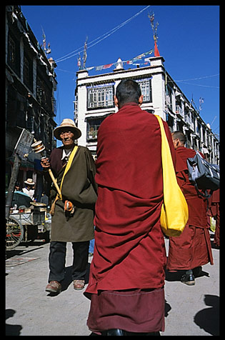 A colourful monk down a narrow alley.