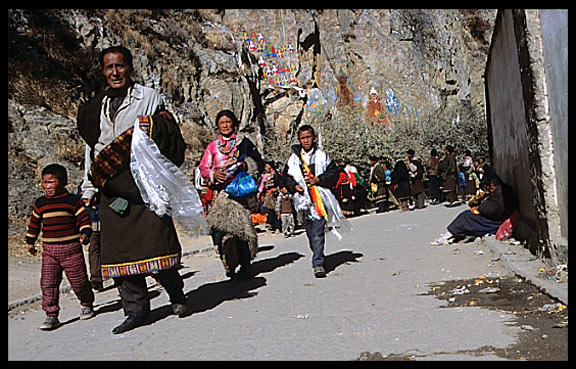 A family of pilgrims follow the Lingkhor Kora.