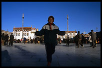 A Chinese girl playing on the Jokhang square. Lhasa, Tibet, China