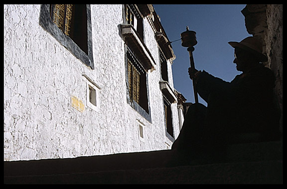 Silhouette of a pilgrim at Drepung Monastery.