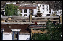 A Tibetan monk on the roof of Drepung Monastery. Lhasa, Tibet, China