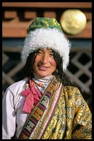 Traditional Tibetan dress in front of the Jokhang. Lhasa, Tibet, China