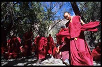 Tibetan monks debate in the monastery's debating courtyard. Sera Monastery. Lhasa, Tibet, China
