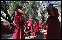 Tibetan monks debate in the monastery's debating courtyard. Sera Monastery. Lhasa, Tibet, China