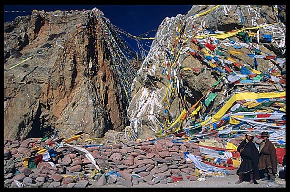 The twin rock towers with prayer flags and mani stones at Nam Tso.