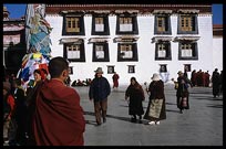 Tibetan pilgrims and monks walking the Barkhor Kora. Lhasa, Tibet, China