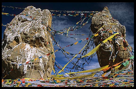 The twin rock towers with prayer flags and mani stones at Nam Tso.