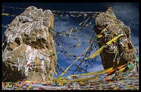 The twin rock towers with Tibetan prayer flags and mani stones at Nam Tso. Nam Tso, Tibet, China