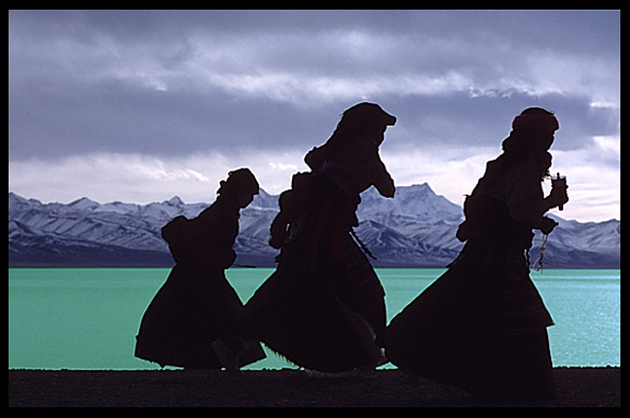 Pilgrims, anxious to finish their Nam Tso Kora, run for the bad weather.