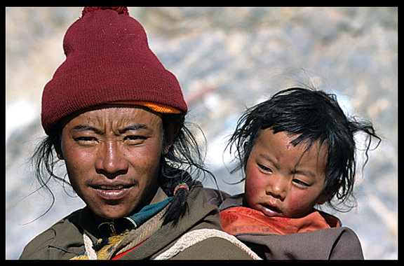 A pilgrim and his young child are walking the Kora at Nam Tso.
