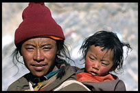 A Tibetan pilgrim and his young child are walking the Kora at Nam Tso. Nam Tso, Tibet, China