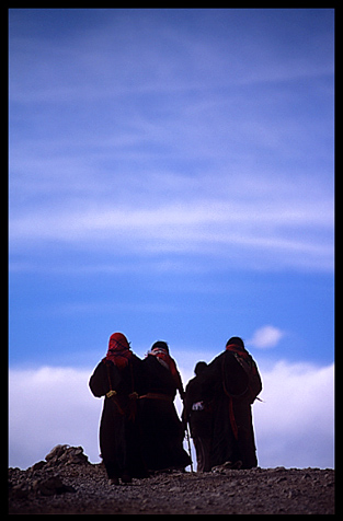 At sunset, the last pilgrims try to finish the Kora at Nam Tso.