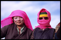 Two very colourful Tibetan pilgrims at lake Nam Tso. Nam Tso, Tibet, China