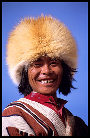 A smiling pilgrim walking the Kora at lake Nam Tso.