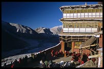 Tibetans travel hundreds of kilometers to bring their deceased relatives to Drigung Til monastery for a sky-burial. Monks receive gifts in the main courtyard just before the sky-burial begins. Tibet, China