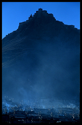 Silhouette of the Gyantse Dzong, a 14th-century fort, towering over the old Tibetan part of Gyantse.